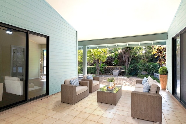 exterior space with lofted ceiling and light tile patterned flooring