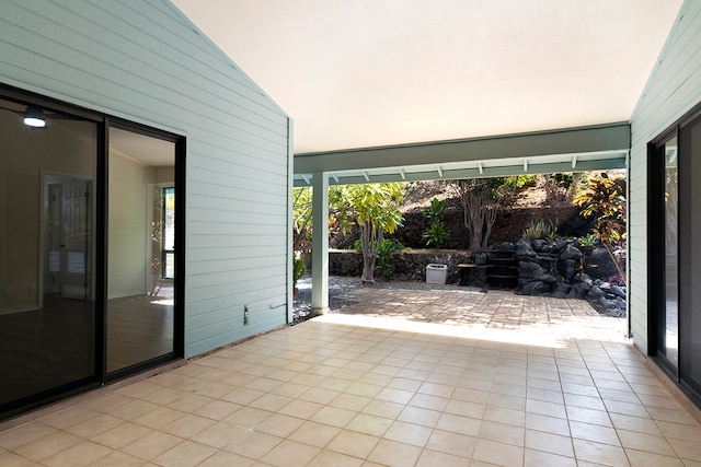 unfurnished sunroom with vaulted ceiling and plenty of natural light