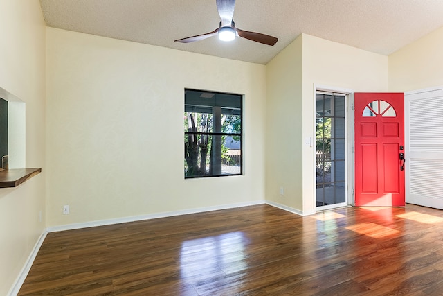 foyer featuring ceiling fan, a textured ceiling, and dark hardwood / wood-style floors