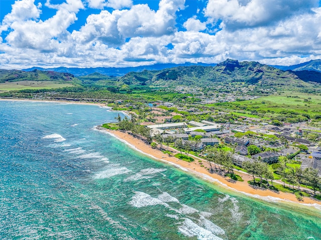 drone / aerial view with a view of the beach and a water and mountain view