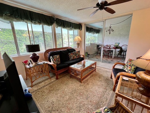 sunroom / solarium featuring ceiling fan