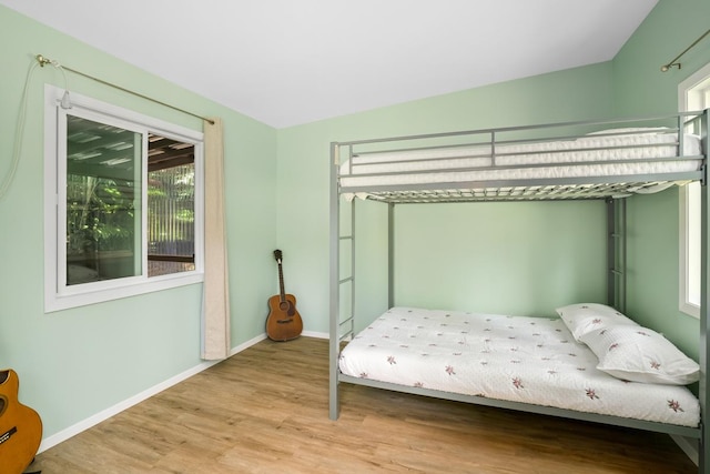 bedroom featuring light wood-type flooring and baseboards