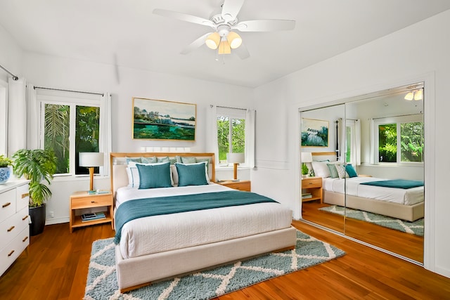 bedroom featuring a ceiling fan, a closet, and dark wood finished floors