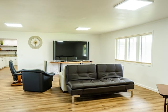 living room with baseboards and light wood finished floors