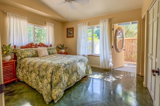 bedroom with ceiling fan, vaulted ceiling, and multiple windows