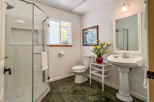 bathroom featuring a shower with shower door, tile patterned floors, and toilet