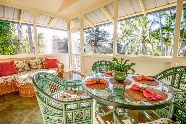 sunroom with vaulted ceiling and a wealth of natural light