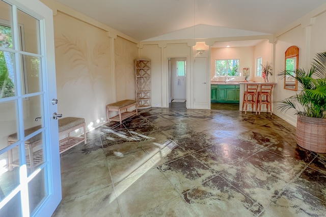 interior space featuring lofted ceiling and dark tile patterned floors