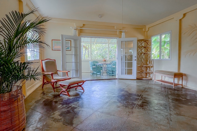 living area featuring french doors and tile patterned flooring