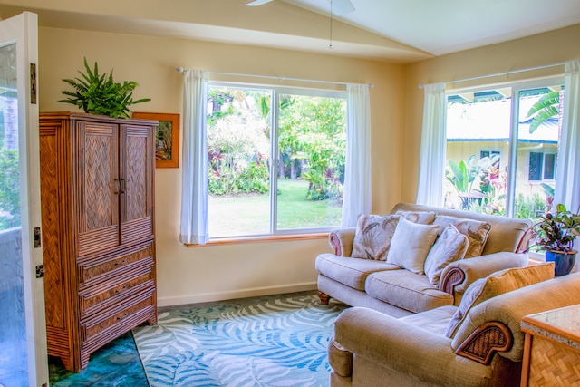 living room with ceiling fan, plenty of natural light, and vaulted ceiling