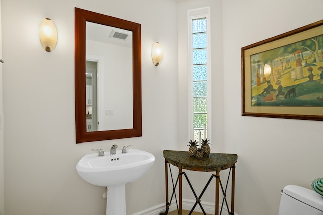 bathroom with toilet and plenty of natural light