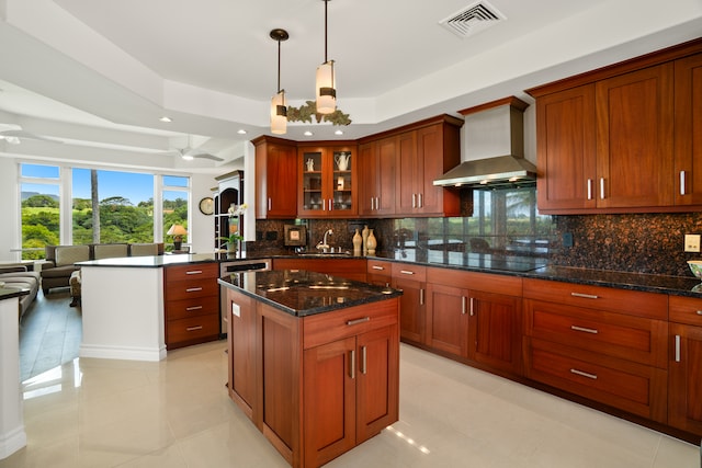 kitchen with light tile patterned floors, black electric stovetop, tasteful backsplash, a raised ceiling, and wall chimney range hood