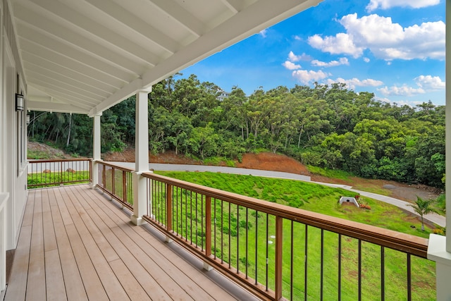 deck featuring covered porch and a yard