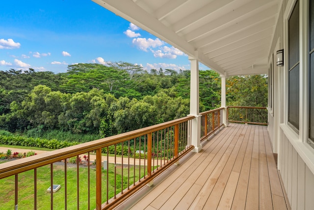 wooden deck with a lawn