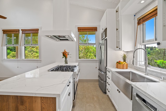 kitchen featuring appliances with stainless steel finishes, sink, white cabinets, and light stone countertops