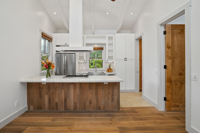 kitchen featuring appliances with stainless steel finishes, light hardwood / wood-style floors, and white cabinetry