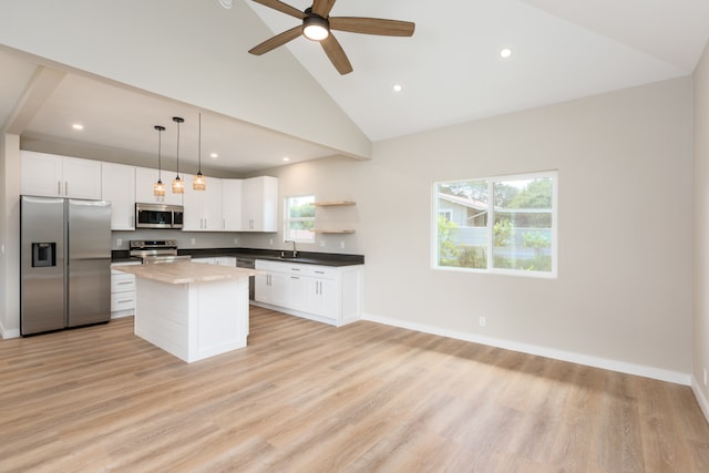 kitchen featuring ceiling fan, a kitchen island, white cabinetry, light hardwood / wood-style floors, and stainless steel appliances