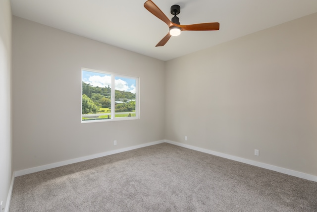 unfurnished room with ceiling fan and carpet