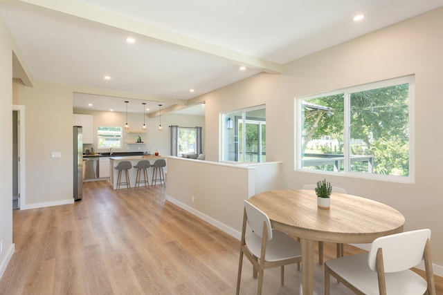 dining room with sink and light hardwood / wood-style floors