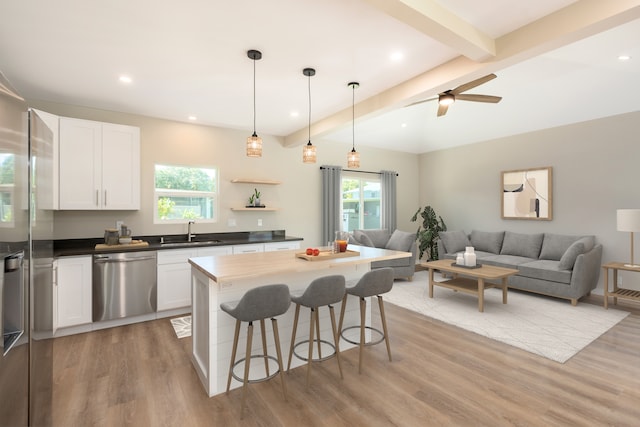 kitchen featuring ceiling fan, hardwood / wood-style flooring, and stainless steel appliances