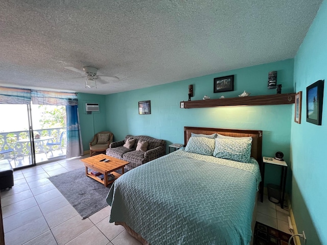 bedroom with light tile patterned floors, ceiling fan, access to outside, a textured ceiling, and an AC wall unit