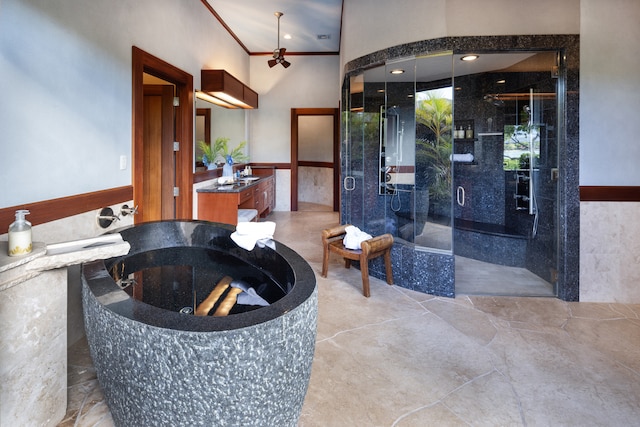 bathroom featuring crown molding, vanity, and separate shower and tub