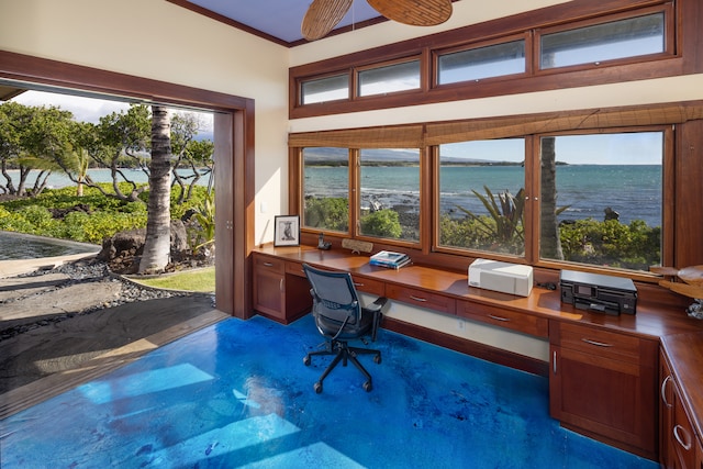 office space featuring ceiling fan, built in desk, ornamental molding, and a water view