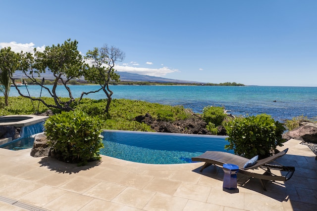 view of swimming pool featuring a patio, a water view, central AC unit, and an in ground hot tub