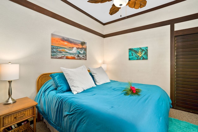 carpeted bedroom featuring ornamental molding and ceiling fan