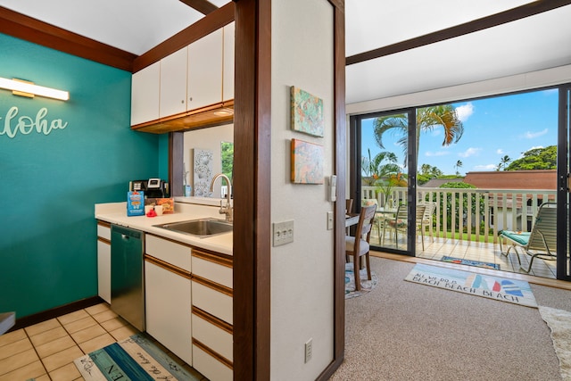 kitchen with stainless steel dishwasher, white cabinetry, plenty of natural light, and sink