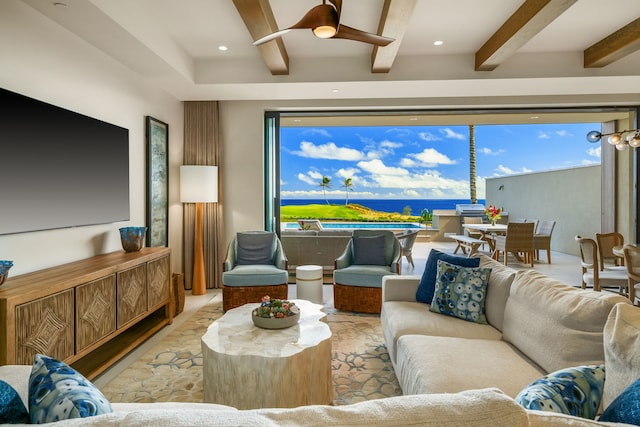 living room with ceiling fan, a water view, and beam ceiling