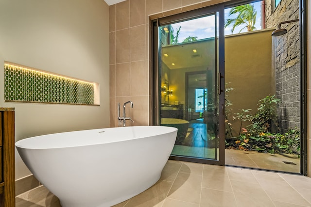 bathroom featuring separate shower and tub, tile patterned floors, and tile walls