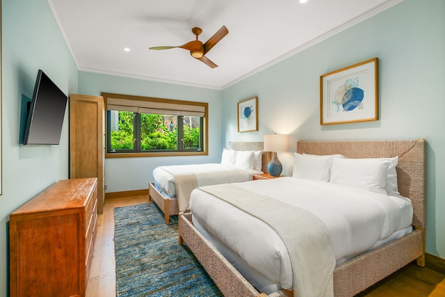 bedroom with crown molding, ceiling fan, and wood-type flooring