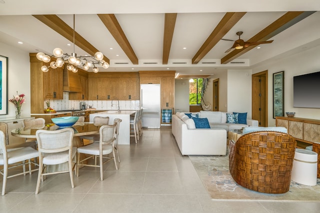 kitchen with tasteful backsplash, a breakfast bar, custom range hood, decorative light fixtures, and white fridge