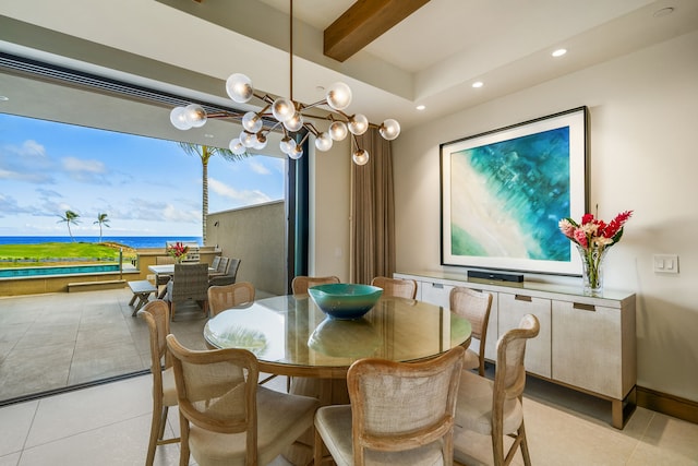 dining space with a water view, beamed ceiling, light tile patterned floors, and an inviting chandelier