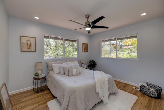 bedroom with recessed lighting, baseboards, and wood finished floors