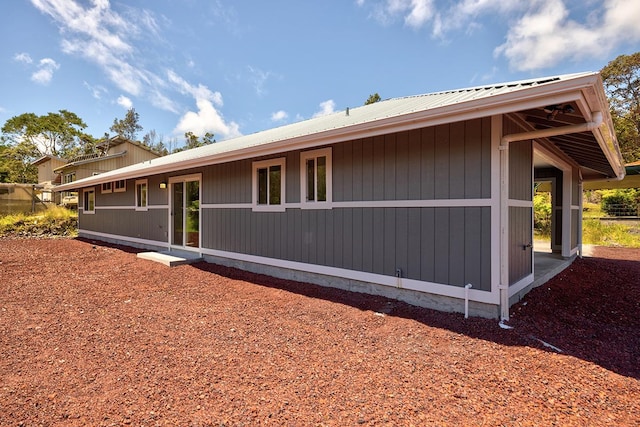 view of side of home featuring metal roof