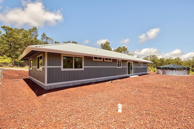 view of side of property with metal roof