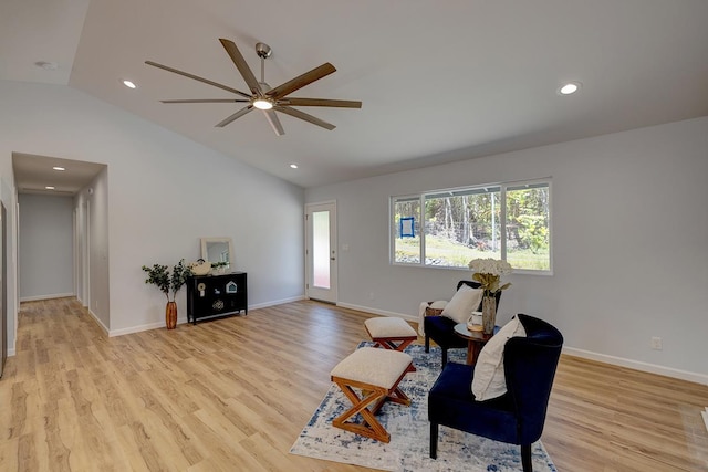 living area featuring recessed lighting, light wood-style flooring, baseboards, and vaulted ceiling