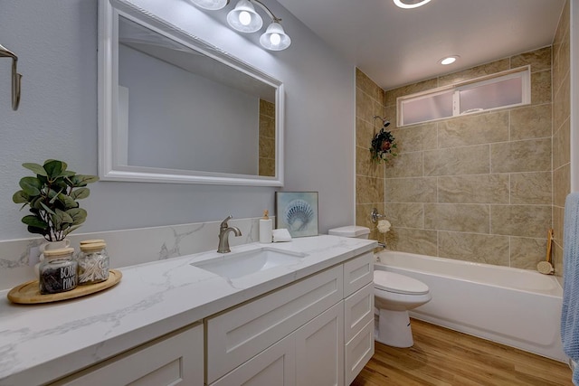 bathroom featuring shower / bathing tub combination, toilet, wood finished floors, and vanity