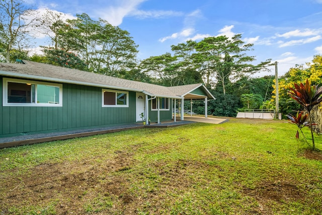 back of property featuring a yard and a patio area