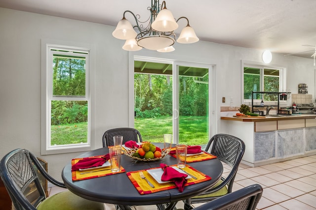 tiled dining area with an inviting chandelier