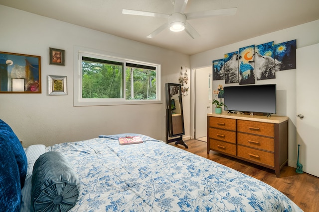 bedroom featuring ceiling fan and dark hardwood / wood-style floors