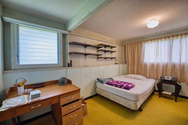 bedroom with beamed ceiling, a textured ceiling, and light carpet