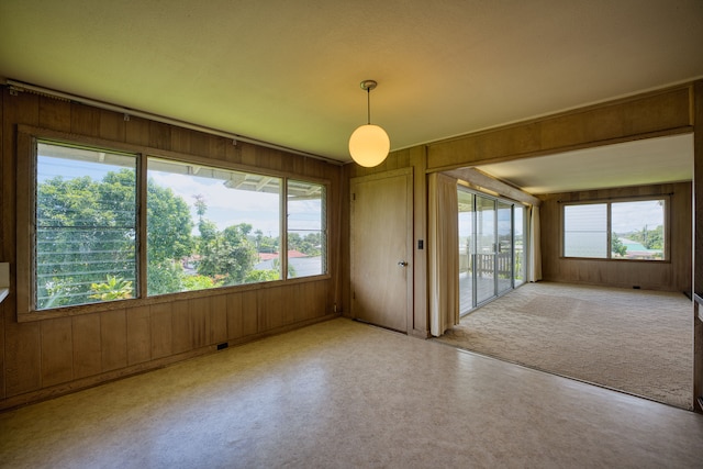 spare room with wood walls