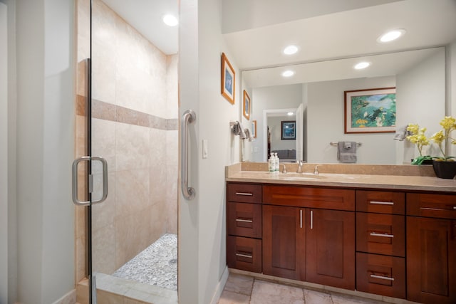 bathroom with tile patterned flooring, vanity, and an enclosed shower