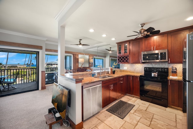 kitchen with ornamental molding, kitchen peninsula, sink, ceiling fan, and appliances with stainless steel finishes