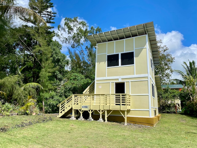 rear view of house with a yard