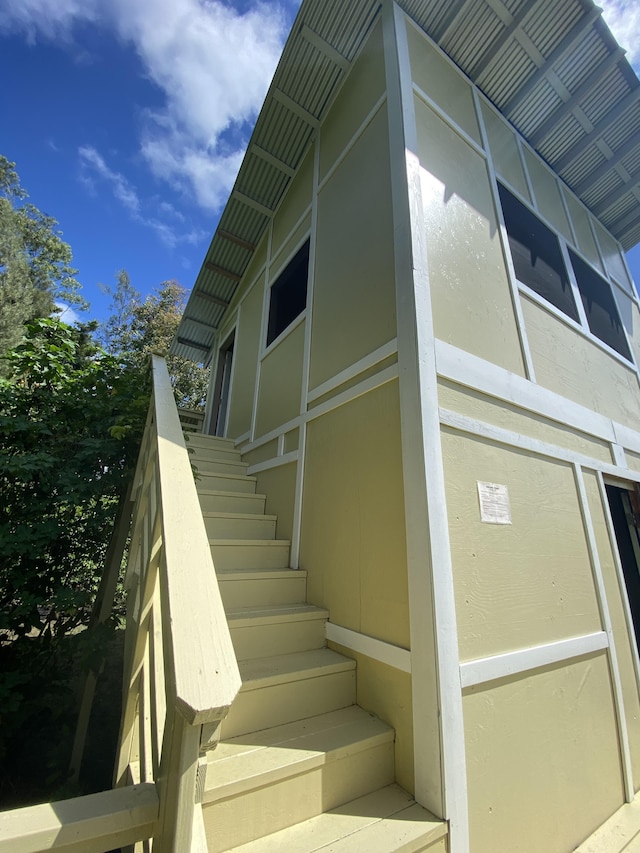 view of property exterior featuring stairs and stucco siding