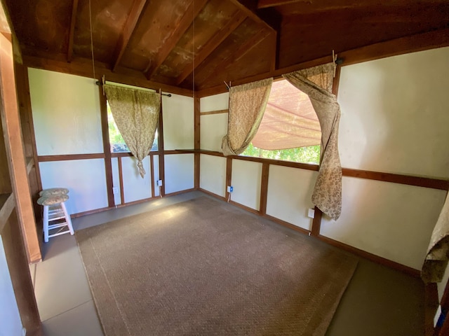 unfurnished sunroom featuring lofted ceiling and a healthy amount of sunlight